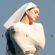 Person wearing a white outfit with a hood against a blue sky, featuring the word 'LUX'.