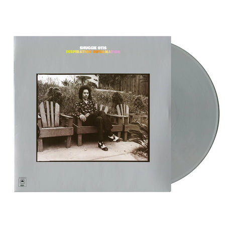 Vinyl record with cover featuring a person sitting on a bench in a garden, on a white background.