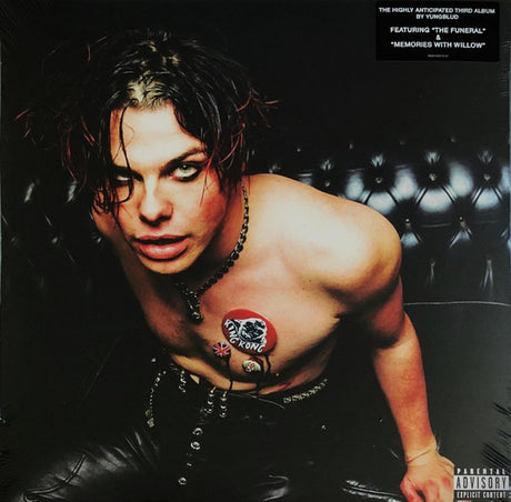 Person with tattoos on a vinyl record cover with text and album art elements.