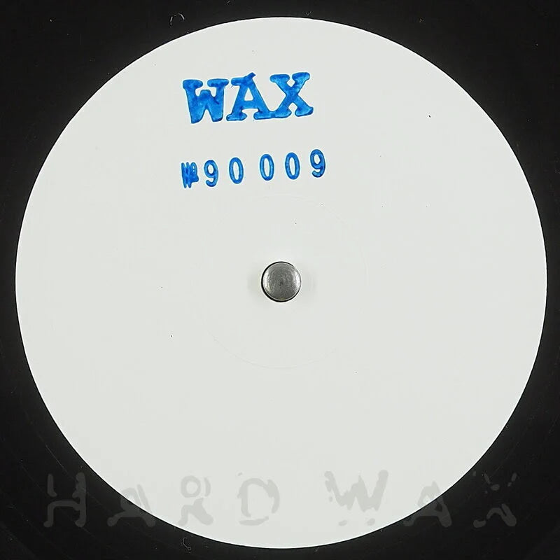 Close-up of a vinyl record with 'WAX' branding and number on a white label.
