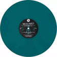 Teal vinyl record with a black label featuring 'Nacho Marco' on a white background
