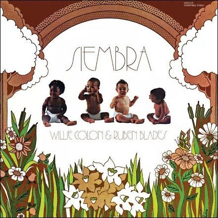 The cover of the vinyl LP 'Siembra' featuring images of babies and the text 'SIEMBRA' in a stylized font, with a background of a flower and a patterned wall.