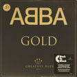 ABBA - Gold (Greatest Hits) album cover featuring the band's name in gold letters on a black background, with a badge indicating '40th Anniversary Edition' and a Back to Black record label.