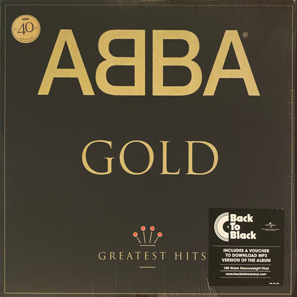 ABBA - Gold (Greatest Hits) album cover featuring the band's name in gold letters on a black background, with a badge indicating '40th Anniversary Edition' and a Back to Black record label.