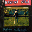 Album cover for Bikini Kill's 'Pussy Whipped LP' featuring a person standing in a field with a backdrop of trees and sky.