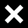 Record cover with a large white cross on a black background, representing the band The XX.