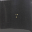 A black vinyl record with a gold-colored cross on the cover.