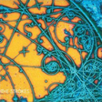 This image features the album cover for "Is This It" by The Strokes. The cover art is striking with its vibrant, psychedelic design, showcasing a complex pattern of intertwined lines and shapes in shades of blue, orange, and gray.