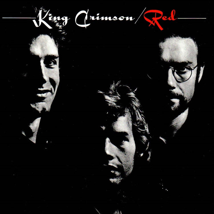 Album cover for King Crimson's Red LP featuring a black and white photograph of the band members with the band name and album title text.